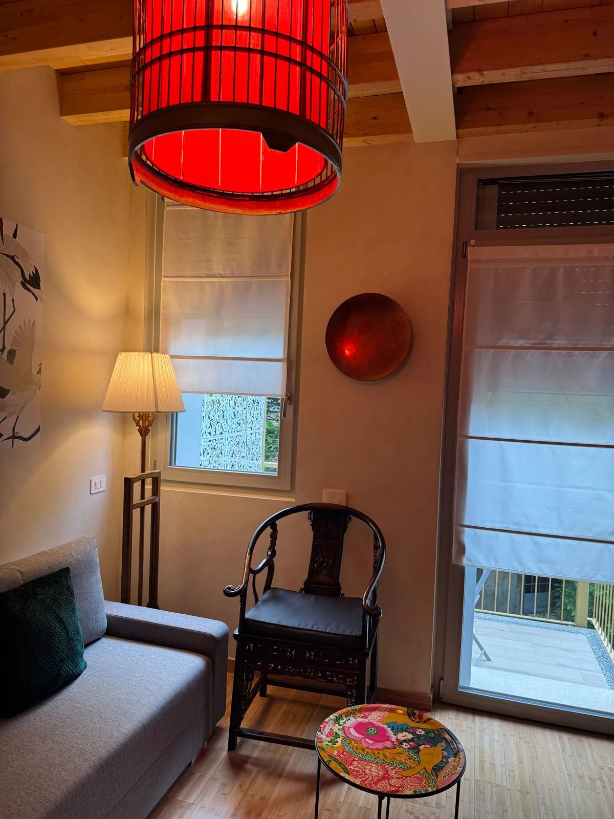 Living area with red lamp and parquet floor